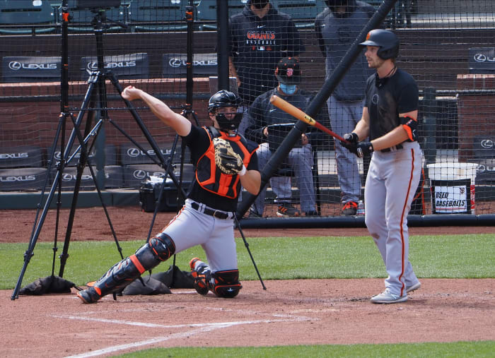 SF Giants catcher Patrick Bailey throws a ball back to the pitcher while Austin Slater bats at the alternate site. (2020)
